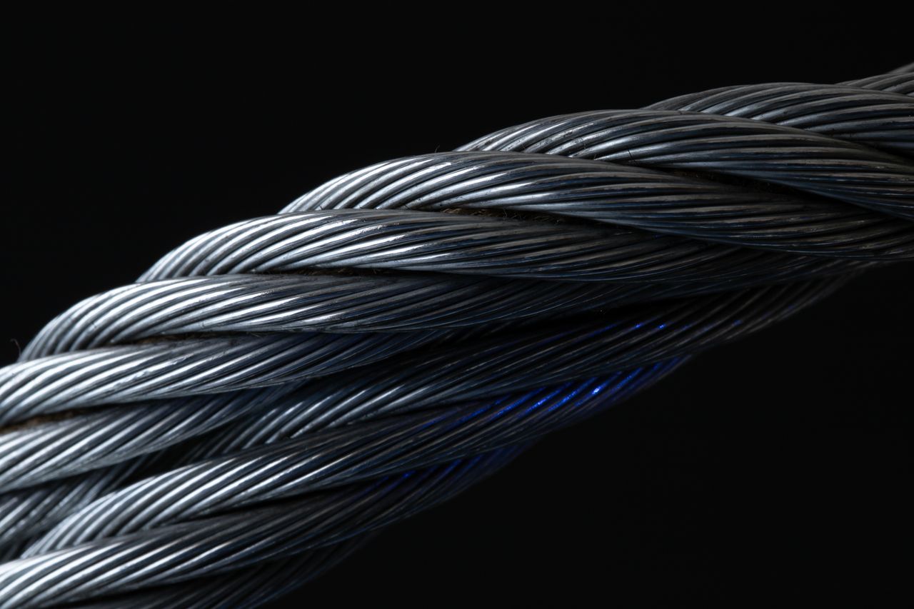 about-bg Detailed view of twisted metal wire showing intricate patterns and texture.